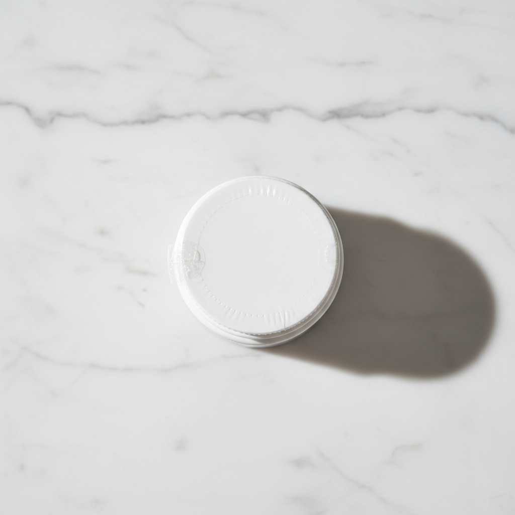Top-down view of Thorne supplement bottle cap, factory sealed