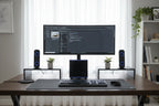Professional desktop arrangement featuring satellite speakers and central subwoofer component