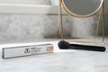 Arbonne The Real Conceal Liquid Concealer Tan on marble makeup vanity with natural daylight lifestyle