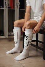 G-Form Pro-S Vento Shin Guards Large being slipped under white soccer sock in locker room