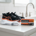 Lotrimin Ultra Athlete's Foot Cream box on bathroom countertop with athletic socks and running shoes