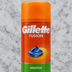 Close view of orange Gillette Fusion Sensitive can front label