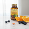 Kids multivitamin tablet on marble countertop beside fresh orange slices and blueberries – More4less Outlet