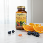 Kids multivitamin tablet on marble countertop beside fresh orange slices and blueberries – More4less Outlet