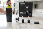 Houdini self-pulling corkscrew in action opening red wine bottle on marble counter - More4less Outlet