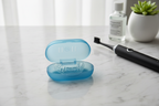 DenTek Professional-Fit dental guard resting in open antimicrobial Germ Shield storage case on marble
