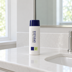 Rodan + Fields SPOTLESS Step 2 bottle on a white bathroom sink counter