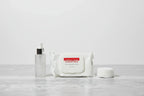 Professional studio setting with makeup remover wipes pack on neutral surface, minimalist beauty product photography