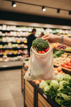SuperBee organic cotton mesh produce bag being used at grocery store produce section sustainable shopping