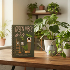 Green Vibes Only houseplant journal beside plants and a watering can, styled lifestyle illustration.
