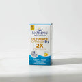 Clean minimalist studio photo capturing daily wellness supplement box on high-quality bright white marble surface