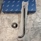 Grohe Rainshower polished chrome wall mount shower arm flat lay on white marble with original Grohe retail box and tissue wrapping