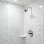 Moen Dartmoor chrome shower trim in minimalist bathroom renovation with subway tile lifestyle image