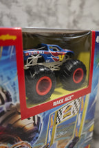 Macro detail shot of Race Ace monster truck model visible through the Hot Wheels Arena Smashers packaging window