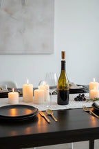 Corkcicle Air wine chiller aerator in wine bottle on modern minimalist dinner table, soft candlelight ambiance