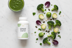 Top-down flat lay of supplement bottle next to fresh broccoli and Brussels sprouts on marble, hormone balance and detox wellness