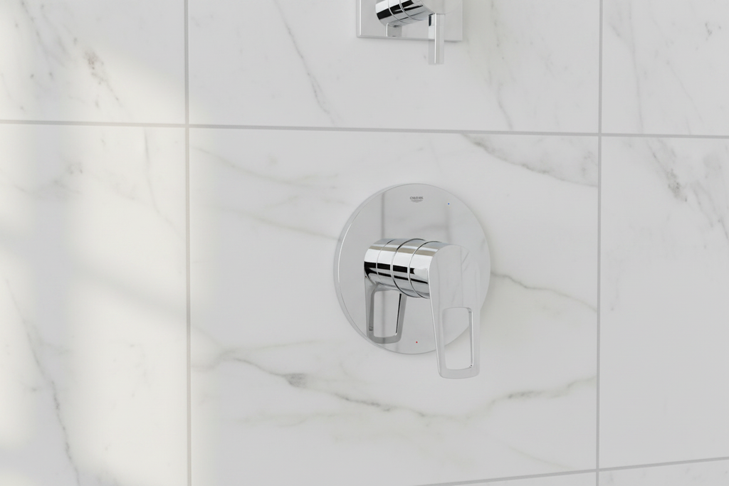 Grohe BauLoop polished chrome shower valve trim on white marble tile in minimalist contemporary bathroom with morning light