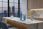 Modern home bar setup with coordinated powder blue barware accessories on marble countertop
