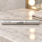 Mary Kay Lash Primer silver tube on a light vanity with a folded cloth