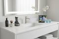 Clean bright bathroom vanity area organized with high-end electric shaver care accessories