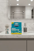 Gillette Mach3 Fresh Clean 4-pack on slate gray bathroom vanity with silver shave brush and glass aftershave bottle