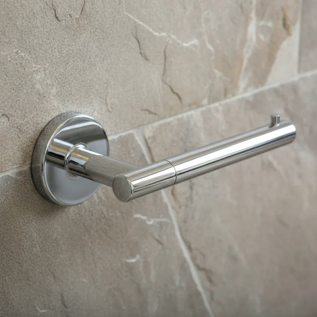 Close-up macro of geometric modern Delta Trinsic chrome bath hardware on a stone wall