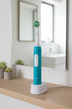 Oral-B Pro 1000 electric toothbrush on charging base on bathroom shelf