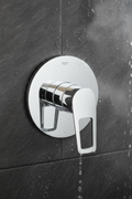Grohe BauLoop polished chrome single-lever shower valve trim with loop handle installed on dark slate tile shower wall