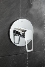 Grohe BauLoop polished chrome single-lever shower valve trim with loop handle installed on dark slate tile shower wall