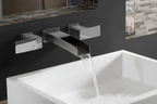Pfister Kenzo polished chrome wall mount faucet with waterfall water flow into modern white vessel sink against dark charcoal wall