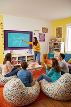 Family laughing and playing Pictionary Air 2 with drawings appearing on TV screen during party game night — More4less Outlet