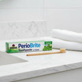 Nature's Answer PerioBrite Coolmint Toothpaste 3-Pack on upscale quartz bathroom vanity with bamboo toothbrush and white hand towel