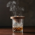 Smoke swirling elegantly inside a Dublin cut-crystal whiskey glass from a wood smoker unit