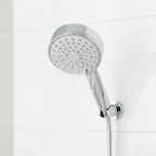 Close-up of Grohe Tempesta Cosmopolitan 100 polished chrome shower head with water spraying from single spray nozzle.