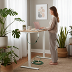 Person working from home at a standing desk with laptop charging via slim adapter in a bright modern home office