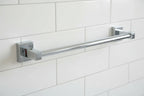 Close-up of chrome bathroom towel bar accessory against neutral tile backsplash