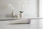 Mary Kay TimeWise Visibly Fit Body Lotion 3oz tube in minimalist spa environment on white marble