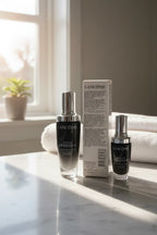 Morning light illuminating premium anti-aging beauty serum products on a white marble bathroom counter