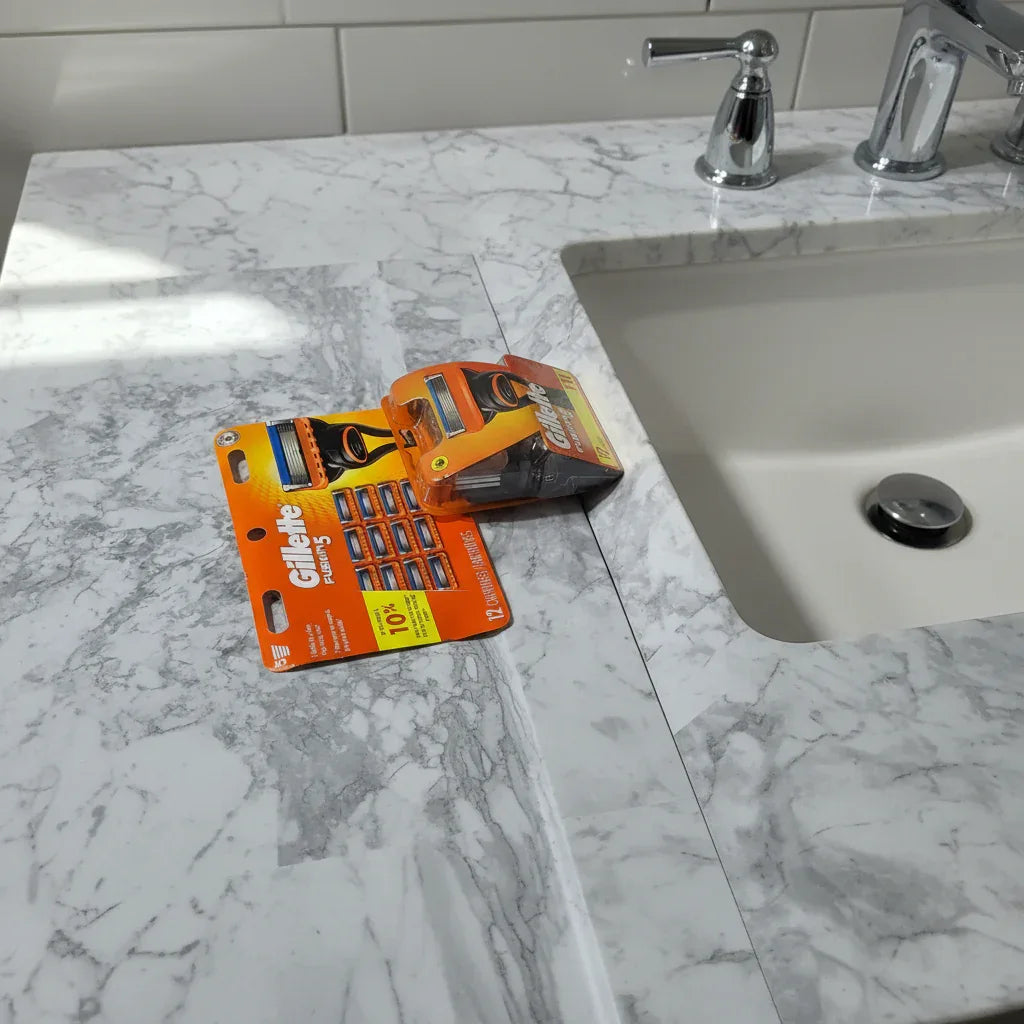 Gillette Fusion5 12ct XXL Razor Refills on marble bathroom countertop