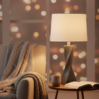 Cozy reading corner vignette with sculptural stone gray twisted table lamp glowing warmly