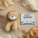 Animal Adventure Lion Plush next to More4less Outlet Stuffed Friend Adoption Certificate gift flat lay - More4less Outlet