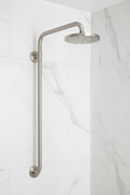 Grohe wall mount shower arm with escutcheon in brushed nickel installed on white marble tile shower wall with water streaming from attached shower head