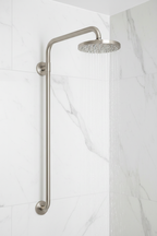 Grohe wall mount shower arm with escutcheon in brushed nickel installed on white marble tile shower wall with water streaming from attached shower head
