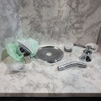 Moen Dartmoor chrome shower trim components studio table shot highlighting polished chrome finish