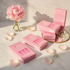 Pink heart-shaped acne patch boxes on white marble vanity with soft morning light and floral accents – More4less Outlet