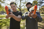 Two players wearing protective eyewear holding Nerf Pro Gelfire blasters in outdoor action lifestyle shot