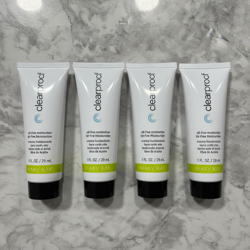 Four Mary Kay Clear Proof Oil-Free Moisturizer tubes standing upright on grey marble - studio shot