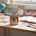 Real Littles Disney Beauty and the Beast Micro Journal displayed on child's desk with school planner, pens, and stickers.