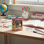 Real Littles Disney Beauty and the Beast Micro Journal displayed on child's desk with school planner, pens, and stickers.