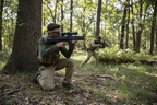Teenagers in tactical gear playing airsoft with Game Face M74DP compact mini AEG airsoft rifle with top hopper — dual power spring and electric 6mm BB